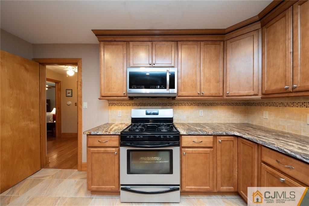144 Upper Ferry Road Ewing, NJ 08628 - Photo 6 of 25 a kitchen with granite countertop a stove and a microwave