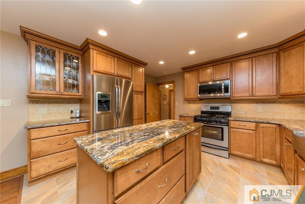 144 Upper Ferry Road Ewing, NJ 08628 - Photo 7 of 25 a kitchen with stainless steel appliances granite countertop a stove top oven a sink dishwasher a refrigerator and cabinets with wooden floor