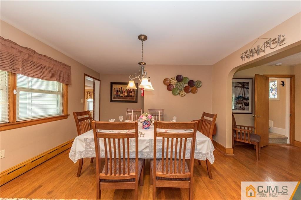 144 Upper Ferry Road Ewing, NJ 08628 - Photo 8 of 25 a view of a dining room with furniture wooden floor and chandelier