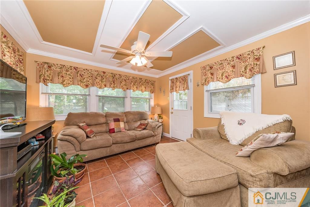 144 Upper Ferry Road Ewing, NJ 08628 - Photo 9 of 25 a living room with furniture and a large window