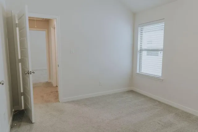 an empty room with closet area