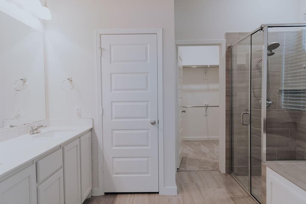 989 Sprangletop Street Allen, TX 75013 - Photo 8 of 20 a bathroom with a shower sink and mirror