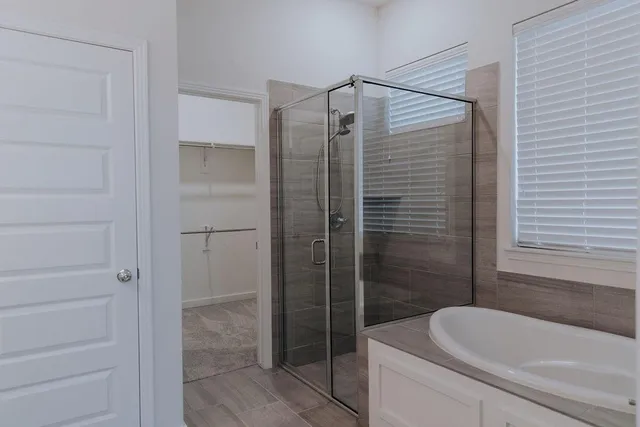 a bathroom with a shower and a bathtub
