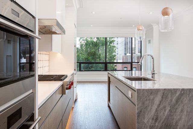 a kitchen with stainless steel appliances granite countertop a sink and a stove