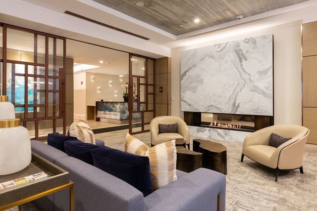 a living room with furniture and a floor to ceiling window