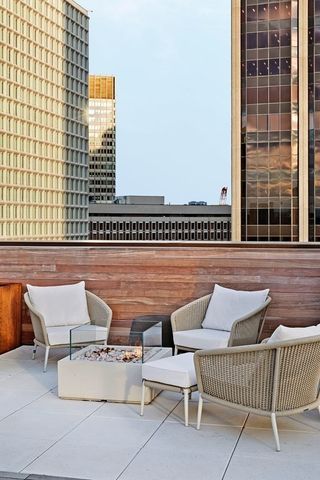 a view of a patio with couches table and chairs and potted plants