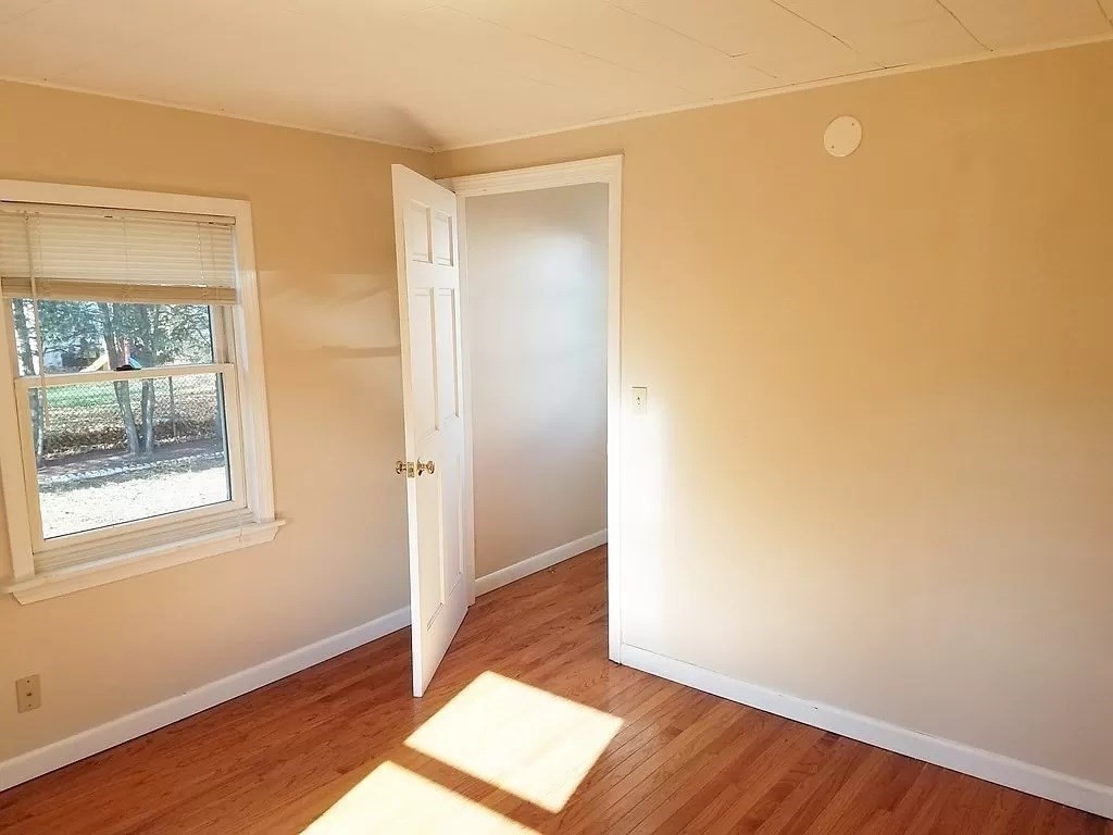 126 Russell Road Newton, MA 02465 - Photo 21 of 27 an empty room with wooden floor and windows