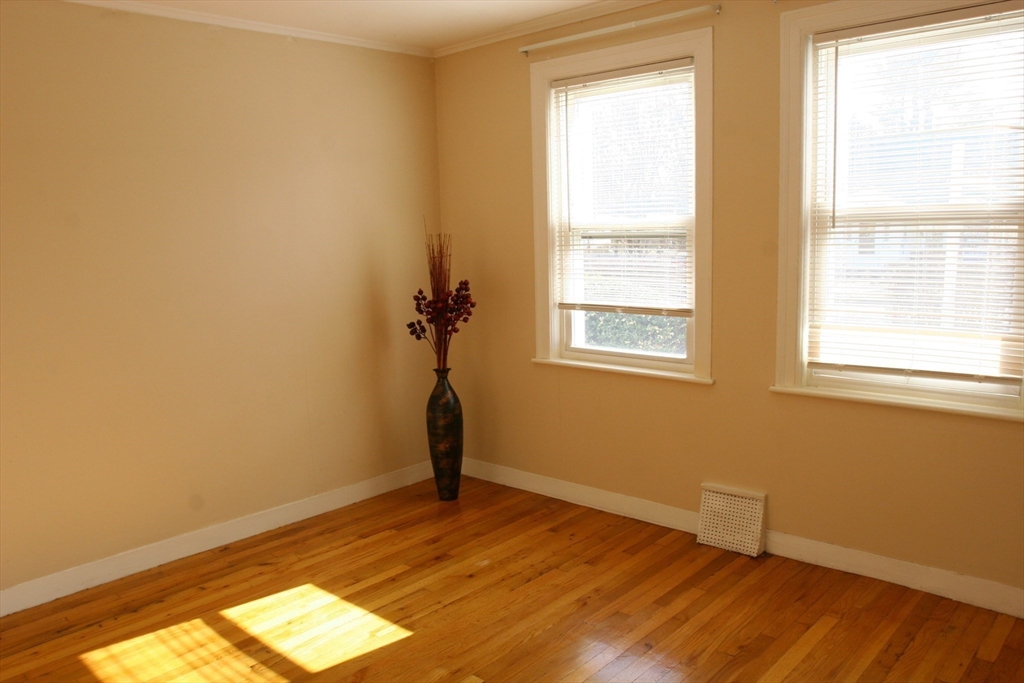 126 Russell Road Newton, MA 02465 - Photo 23 of 27 a view of empty room with wooden floor and fan