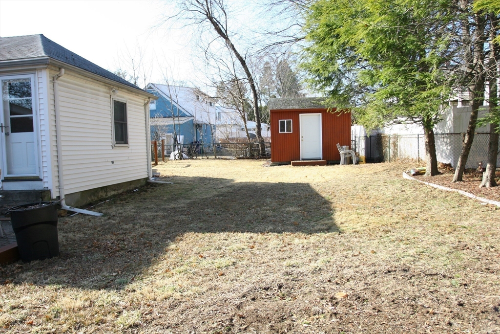 126 Russell Road Newton, MA 02465 - Photo 27 of 27 a front view of a house with a yard covered with snow