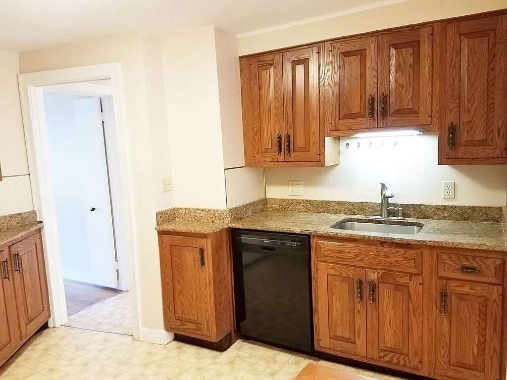 126 Russell Road Newton, MA 02465 - Photo 3 of 27 a kitchen with granite countertop cabinets stainless steel appliances and a counter space