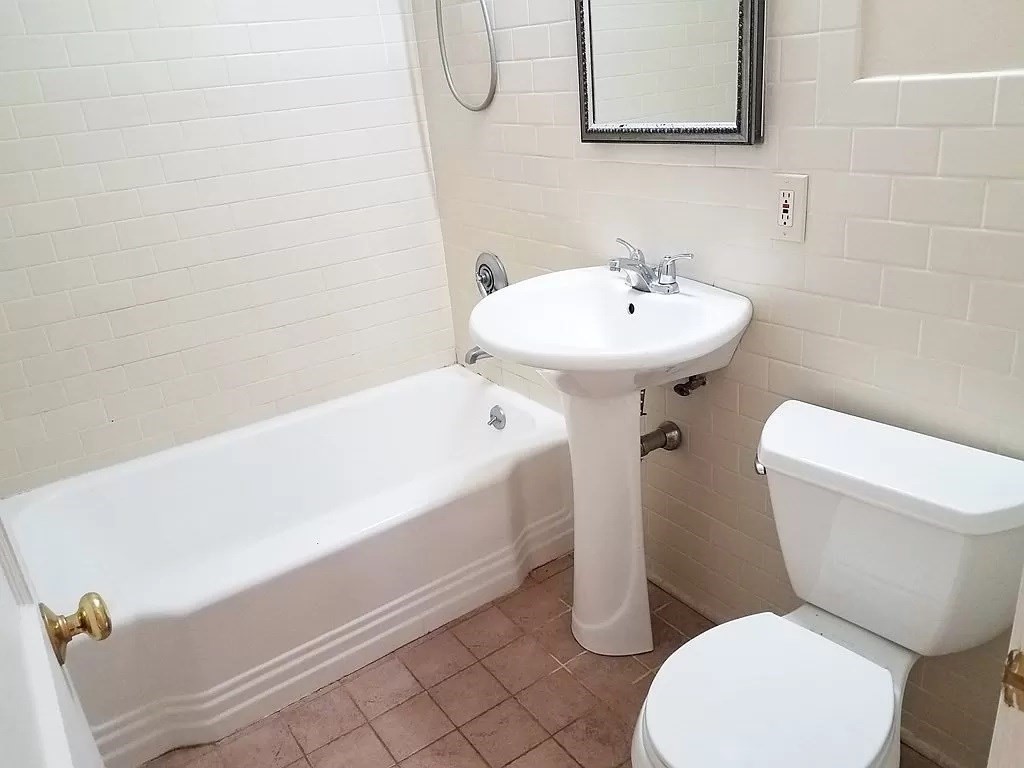 126 Russell Road Newton, MA 02465 - Photo 5 of 27 a bathroom with a sink a toilet and bathtub