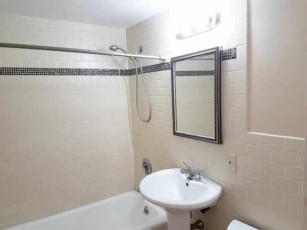 126 Russell Road Newton, MA 02465 - Photo 6 of 27 a bathroom with a sink a mirror and a shower