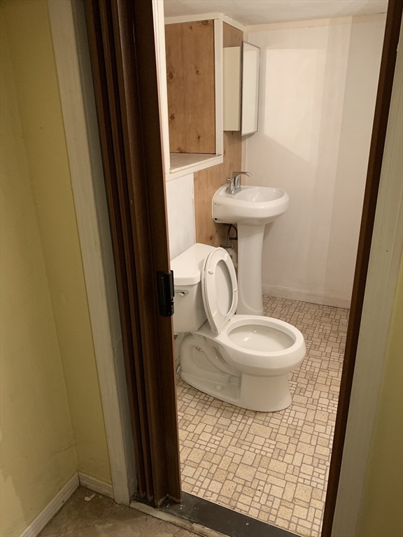 126 Russell Road Newton, MA 02465 - Photo 8 of 27 a bathroom with a sink a toilet and mirror