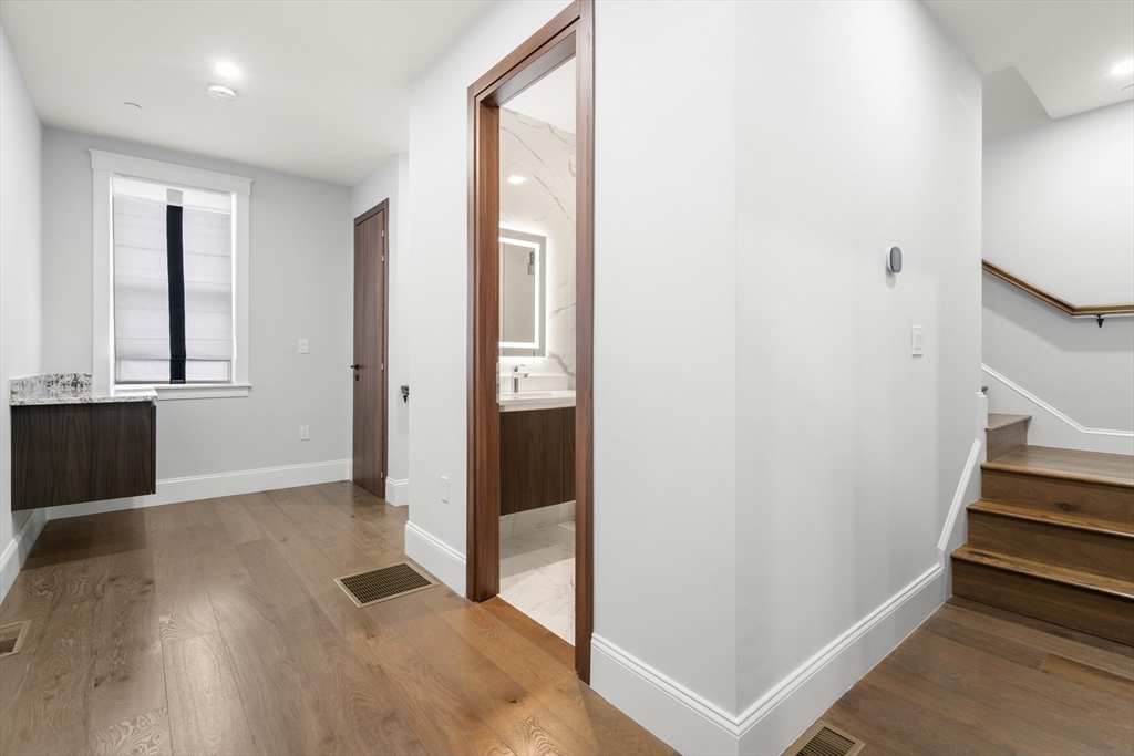 32 Pearl Street, Unit 4 Boston, MA 02125 - Photo 27 of 35 wooden floor in an empty room with a window