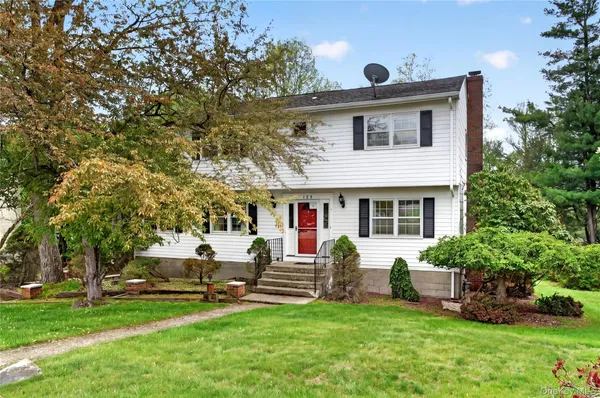 a front view of house with yard and green space