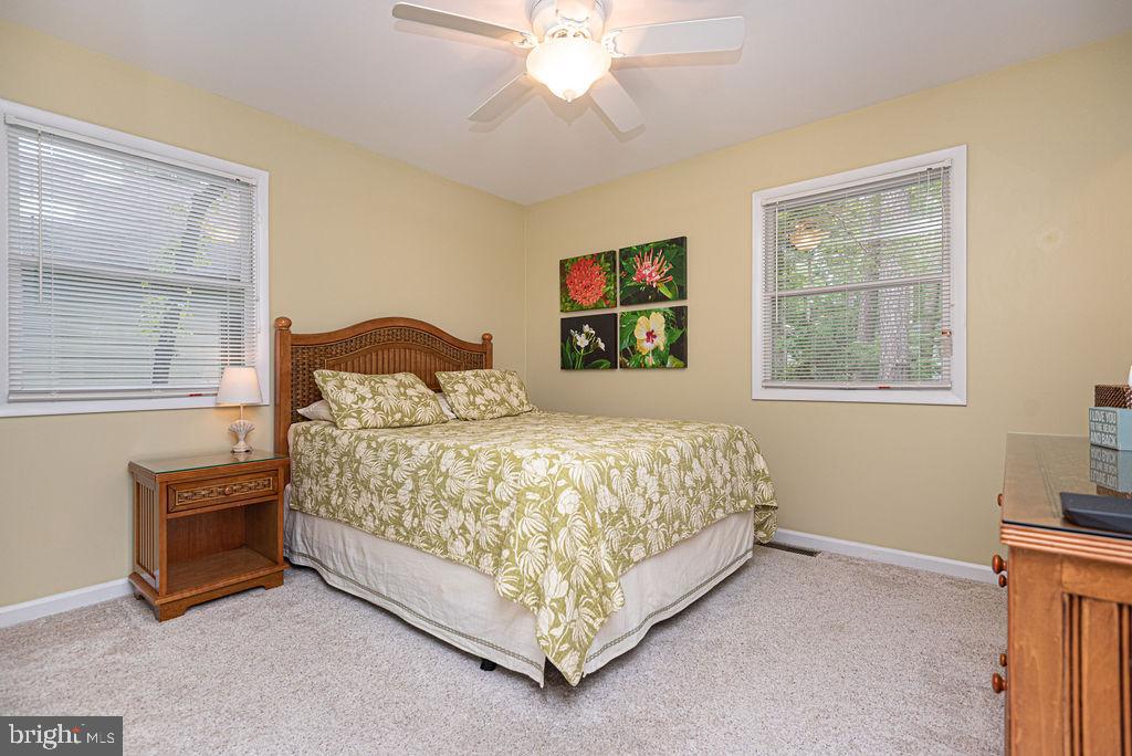 33 Falcon Bridge Road Ocean Pines, MD 21811 - Photo 45 of 71 a bed sitting in a bedroom next to a window