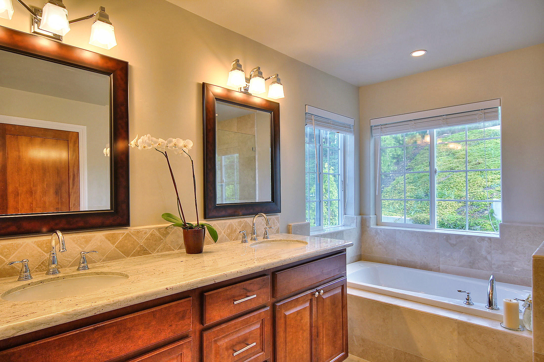 305 Sherman Road Santa Barbara, CA 93103 - Photo 16 of 23 a bathroom with a granite countertop sink and a large mirror
