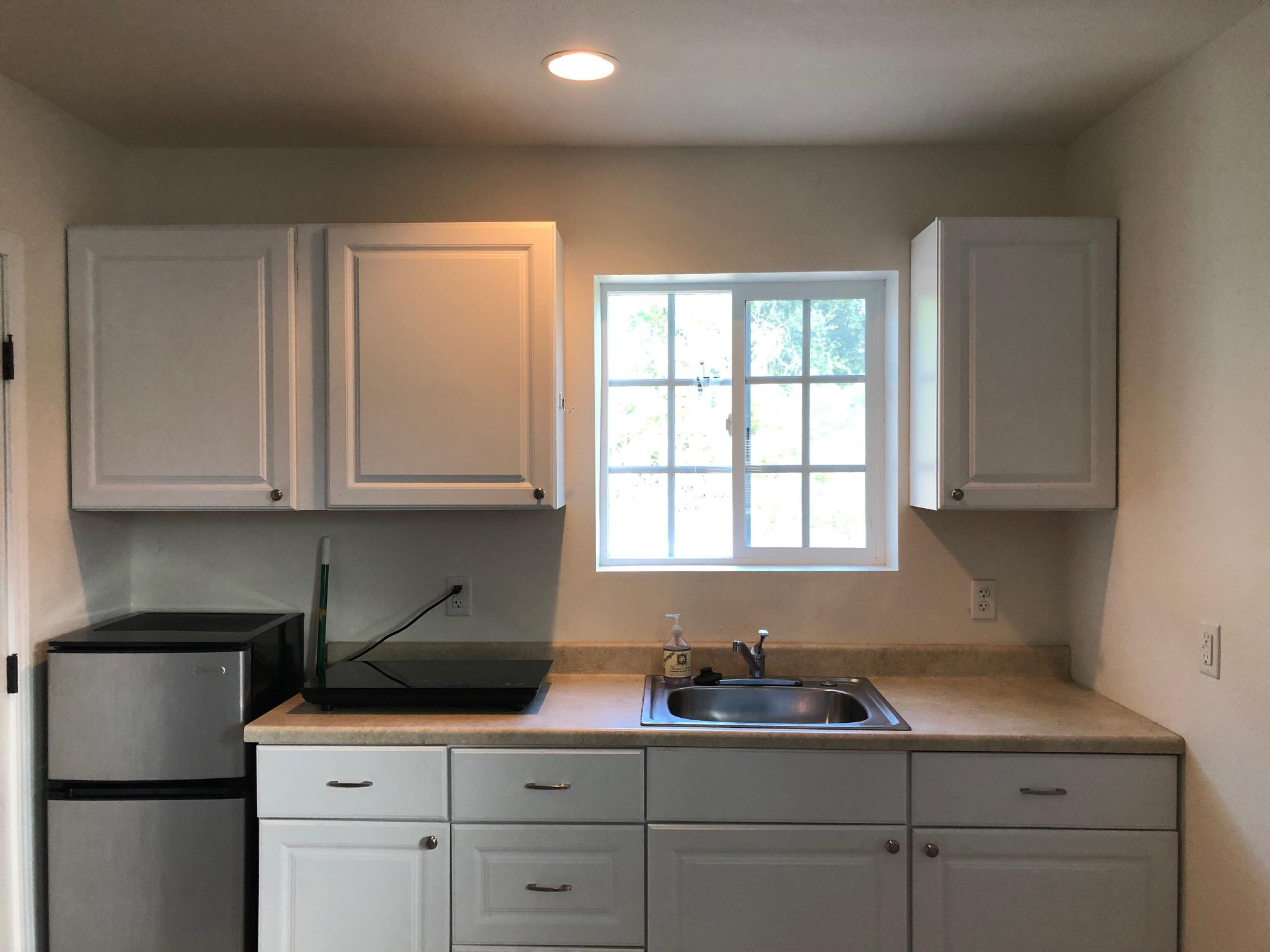 305 Sherman Road Santa Barbara, CA 93103 - Photo 20 of 23 a kitchen with white cabinets and a window