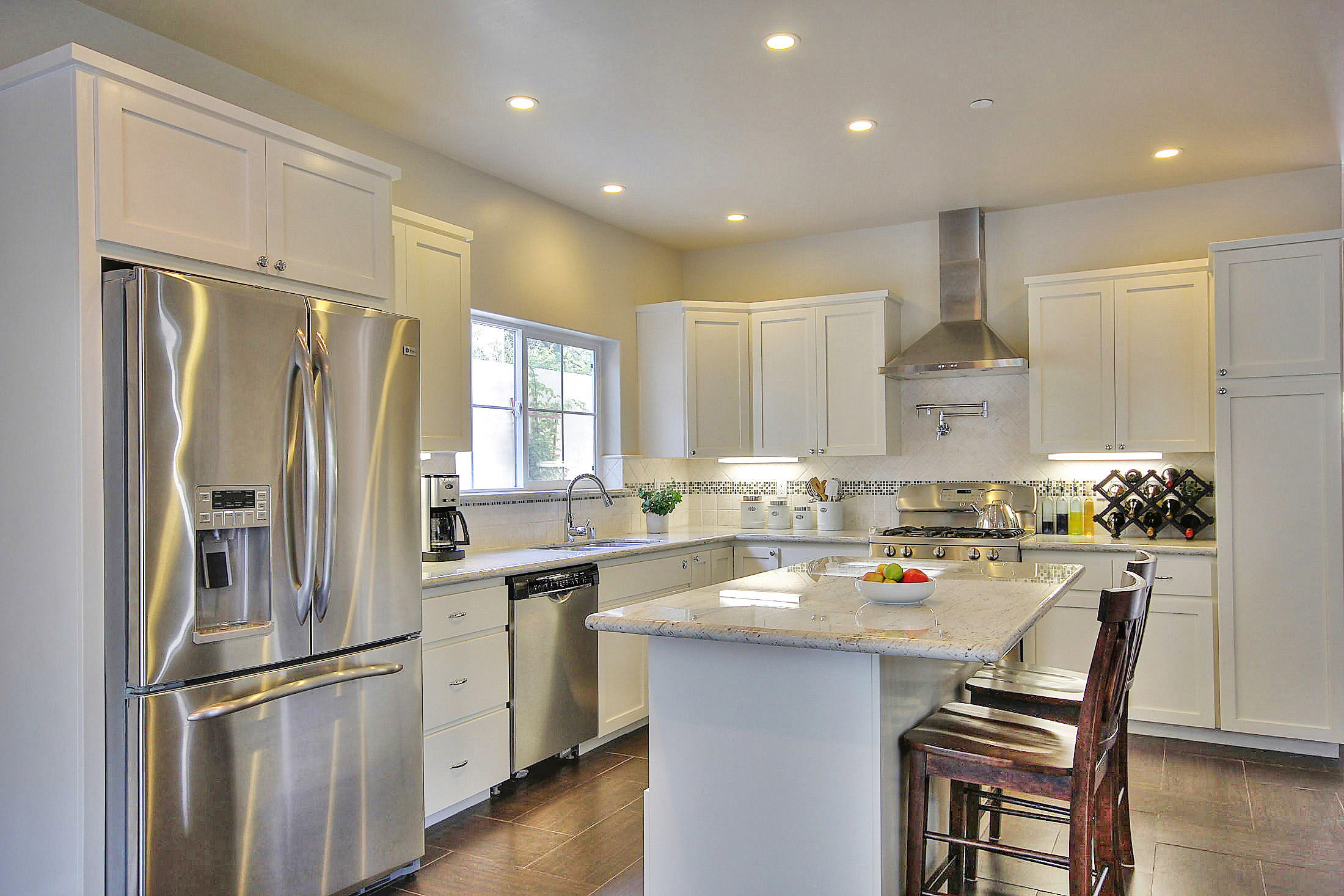 305 Sherman Road Santa Barbara, CA 93103 - Photo 8 of 23 a kitchen with refrigerator cabinets and wooden floor