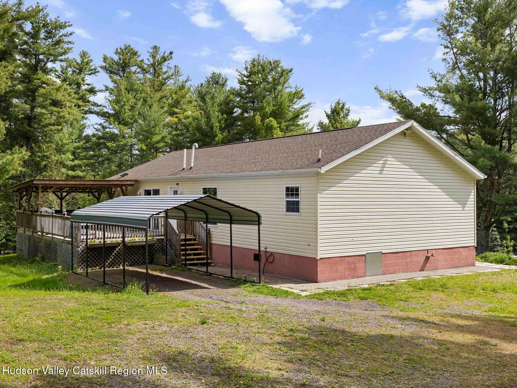 137 Mountain Pond View Road Gilboa, NY 12076 - Photo 5 of 38 a backyard of a house with table and chairs