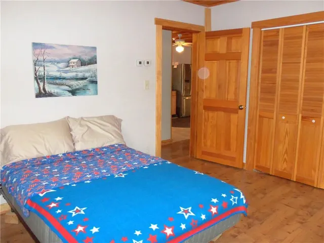 a bedroom with a bed and a chandelier