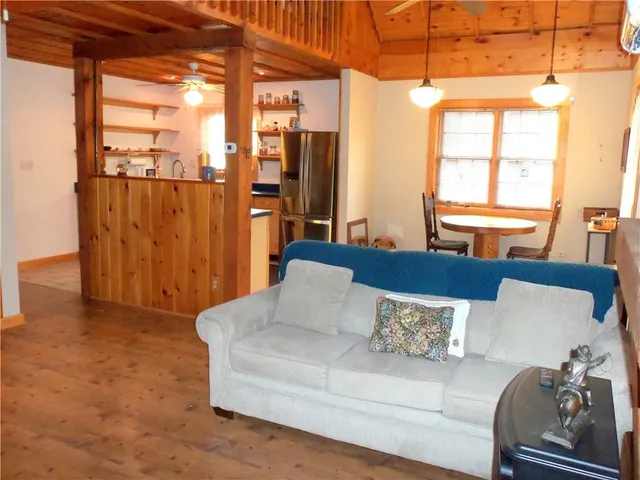 a living room with furniture and a floor to ceiling window