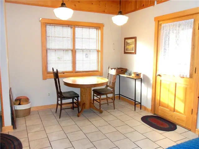 a dining room with furniture and window