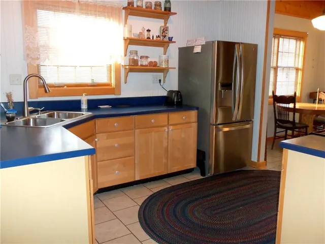 a kitchen with stainless steel appliances granite countertop a refrigerator and a sink