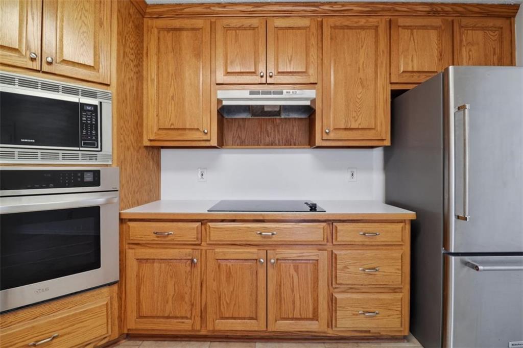 1828 4 Mile Church Road Ball Ground, GA 30107 - Photo 11 of 51 a kitchen with granite countertop cabinets and steel stainless steel appliances