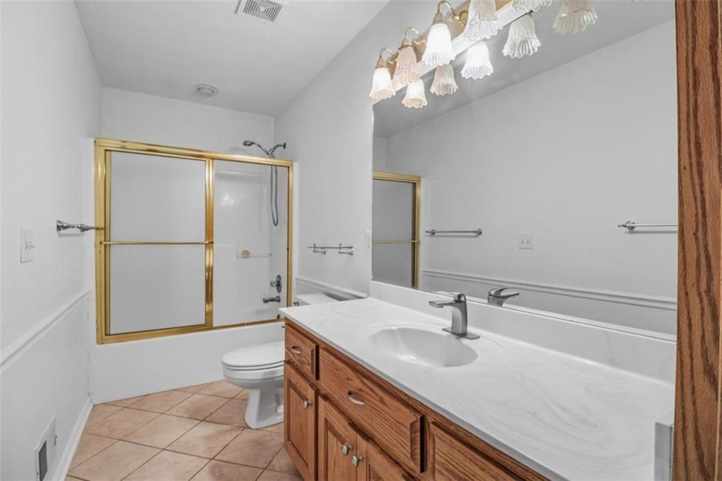 1828 4 Mile Church Road Ball Ground, GA 30107 - Photo 14 of 51 a bathroom with a sink a toilet and shower
