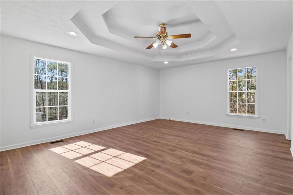 1828 4 Mile Church Road Ball Ground, GA 30107 - Photo 19 of 51 a view of an empty room with wooden floor and window