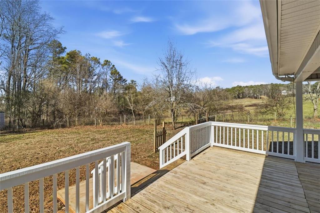 1828 4 Mile Church Road Ball Ground, GA 30107 - Photo 26 of 51 a view of a balcony with wooden floor and fence