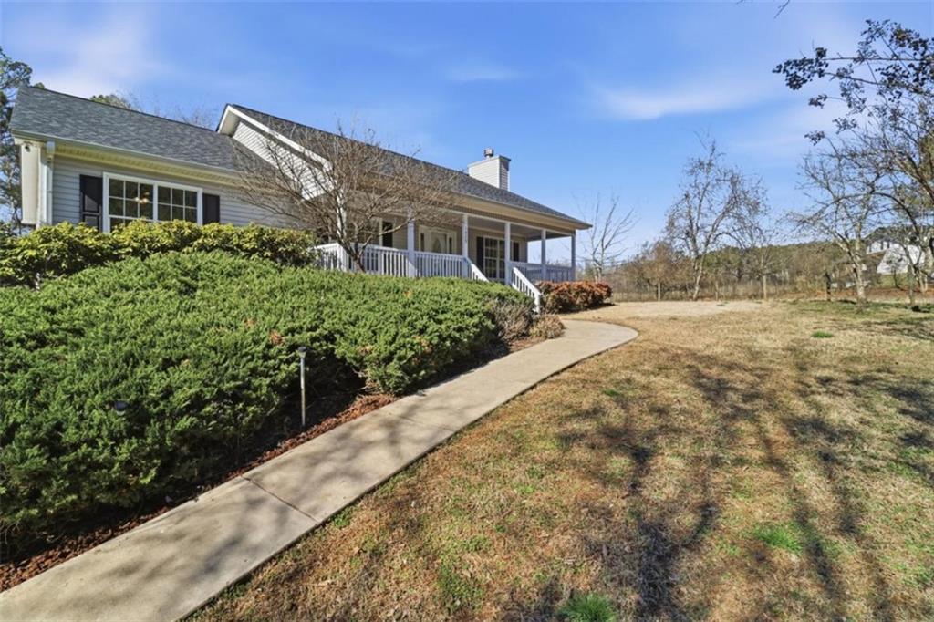 1828 4 Mile Church Road Ball Ground, GA 30107 - Photo 43 of 51 a front view of a house with a yard