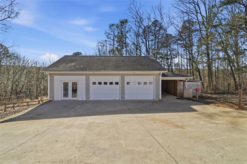 1828 4 Mile Church Road Ball Ground, GA 30107 - Photo 51 of 51 a front view of a house with a yard and garage