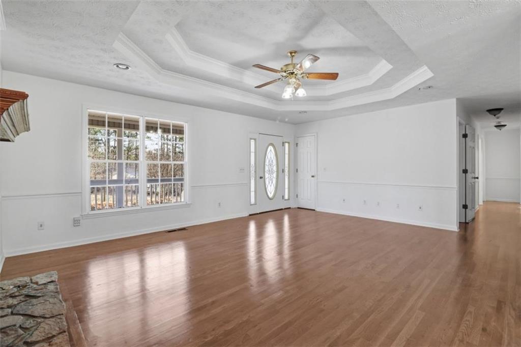 1828 4 Mile Church Road Ball Ground, GA 30107 - Photo 6 of 51 a view of an empty room with wooden floor and a window