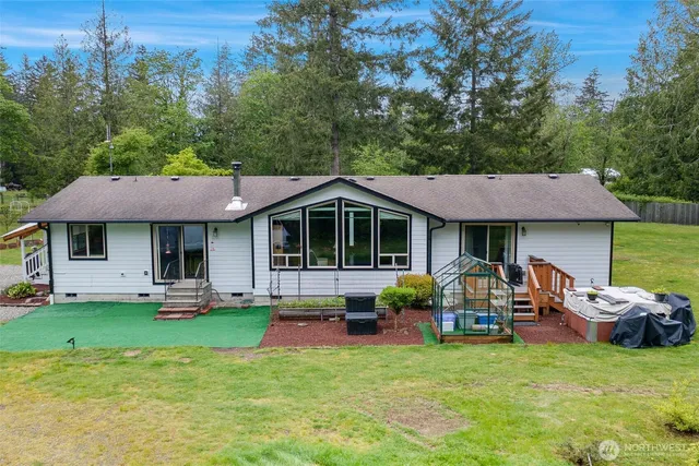 a view of a house with backyard porch and sitting area