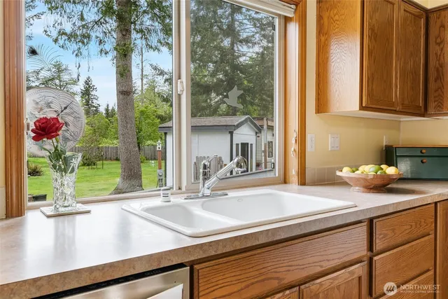 a kitchen with sink and large window
