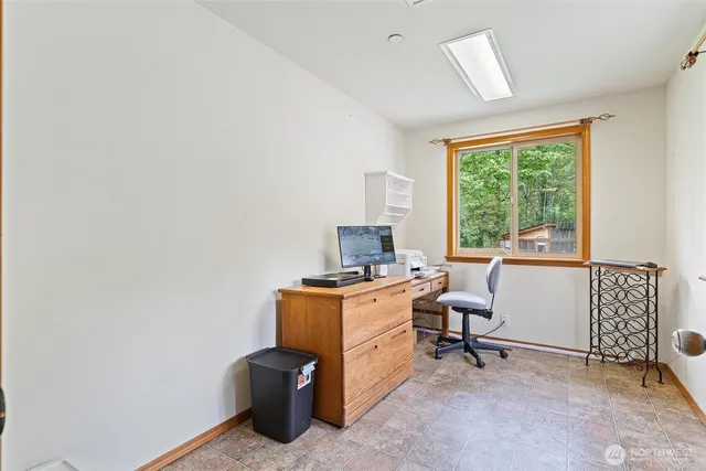 a view of a workspace with furniture and a window