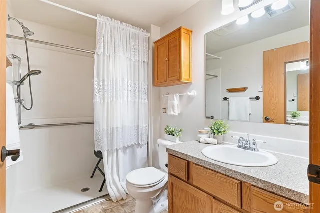 a bathroom with a sink toilet and shower