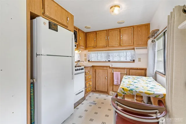 a kitchen with a refrigerator a stove and a refrigerator
