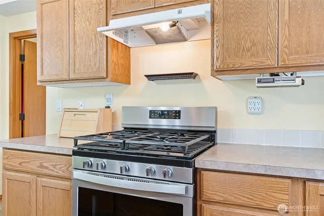 a stove top oven sitting inside of a kitchen
