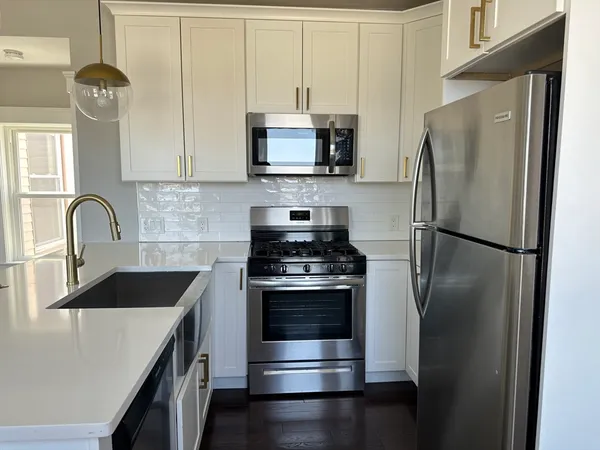 a kitchen with a refrigerator stove and microwave