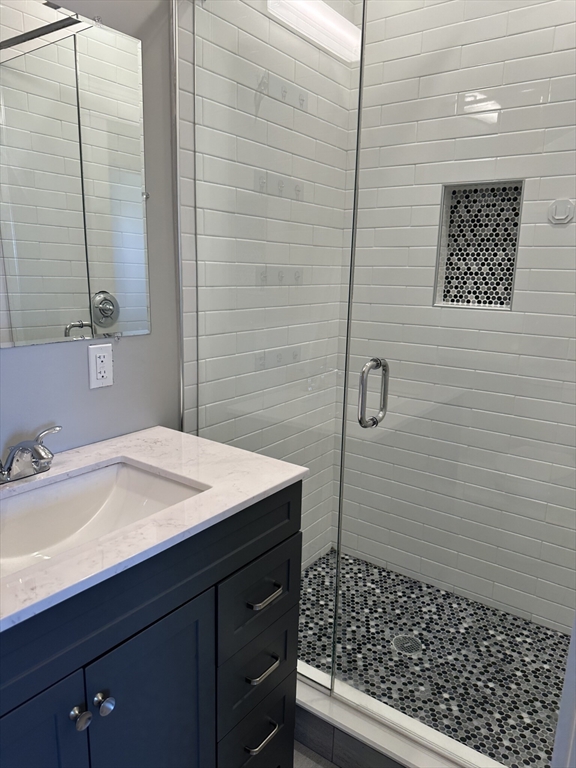 181 Chelsea Street, Unit 3 Everett, MA 02149 - Photo 3 of 10 a bathroom with a sink a toilet and mirror