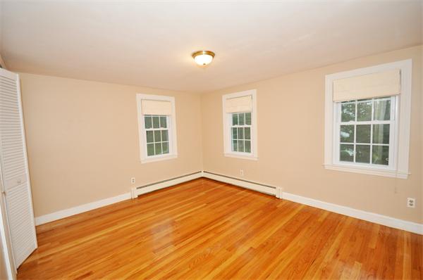 8 Bayberry Road Acton, MA 01720 - Photo 15 of 22 an empty room with wooden floor and windows