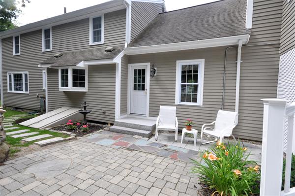 8 Bayberry Road Acton, MA 01720 - Photo 6 of 22 a view of backyard with a chair and bench in patio