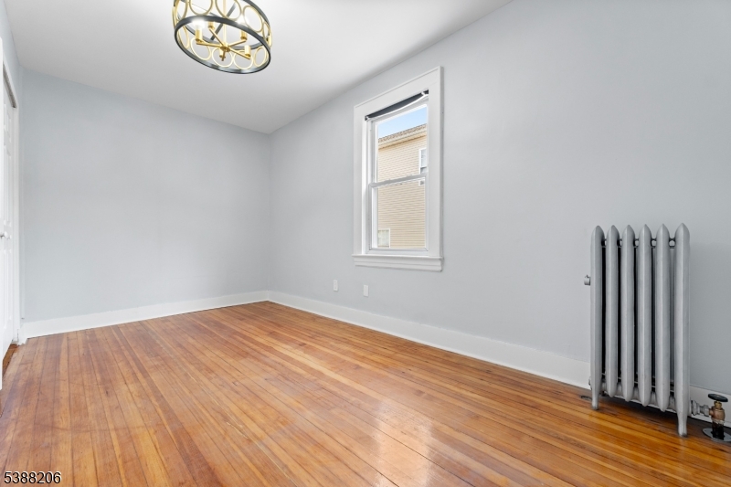 3202 Tremley Point Road Linden, NJ 07036 - Photo 12 of 41 an empty room with wooden floor and windows