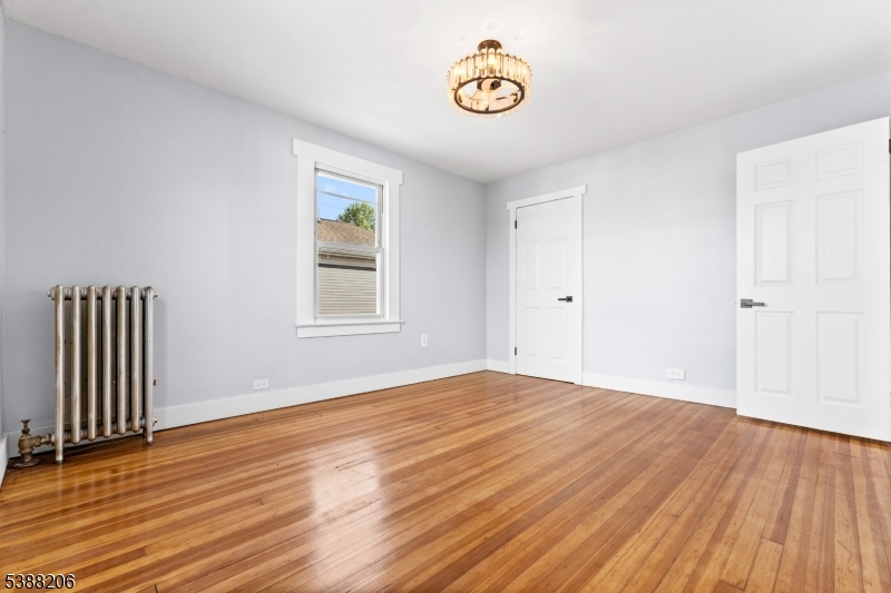 3202 Tremley Point Road Linden, NJ 07036 - Photo 13 of 41 a view of an empty room with wooden floor and a window