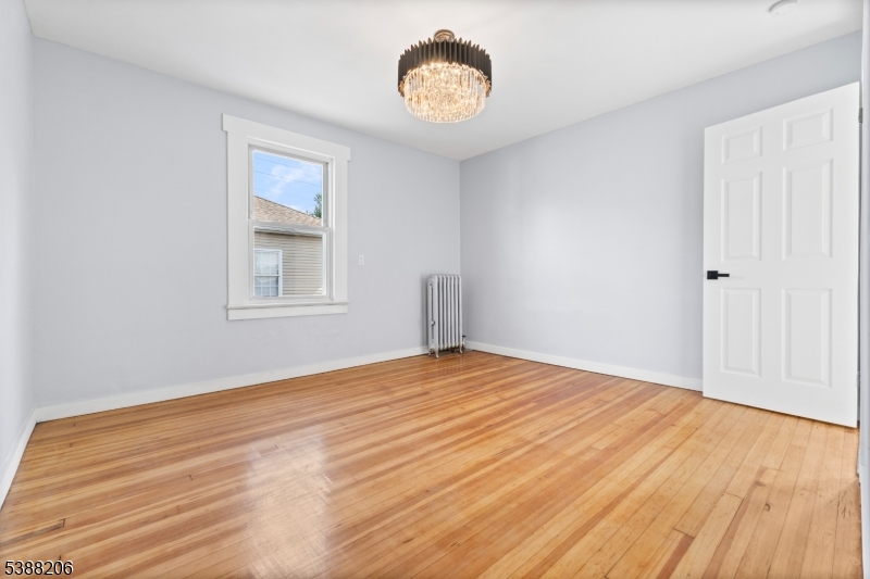 3202 Tremley Point Road Linden, NJ 07036 - Photo 15 of 41 a view of an empty room with wooden floor and a window