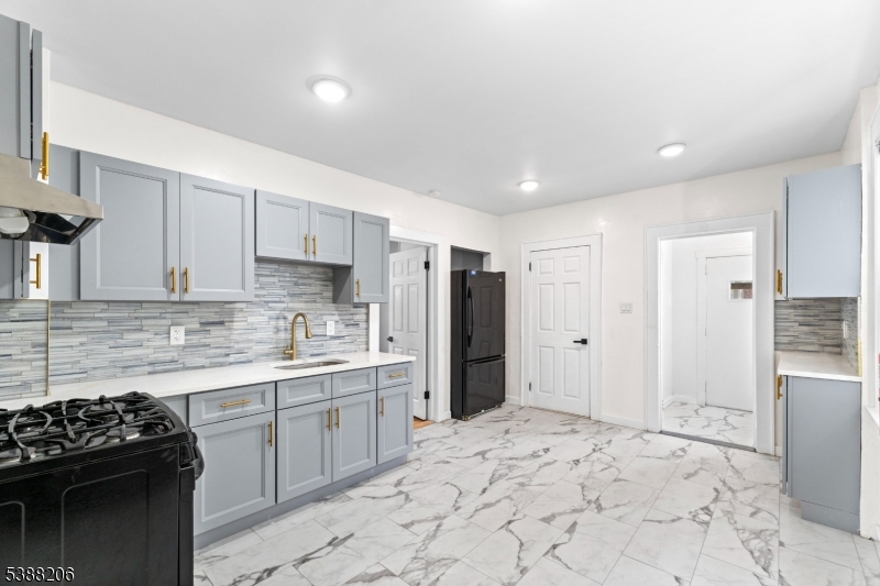 3202 Tremley Point Road Linden, NJ 07036 - Photo 16 of 41 a kitchen with stainless steel appliances granite countertop a stove a refrigerator and a sink