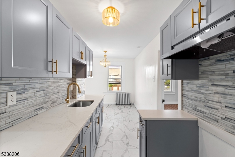 3202 Tremley Point Road Linden, NJ 07036 - Photo 18 of 41 a kitchen with stainless steel appliances granite countertop a sink and a stove